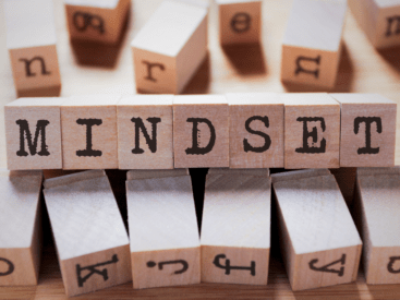 Letter blocks that spell out the word mindset for a blog article about mindset coaching.
